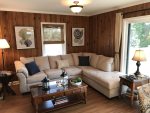Comfortable Living Room Sectional with Full Sofa Sleeper and Slider Door Access to the Deck